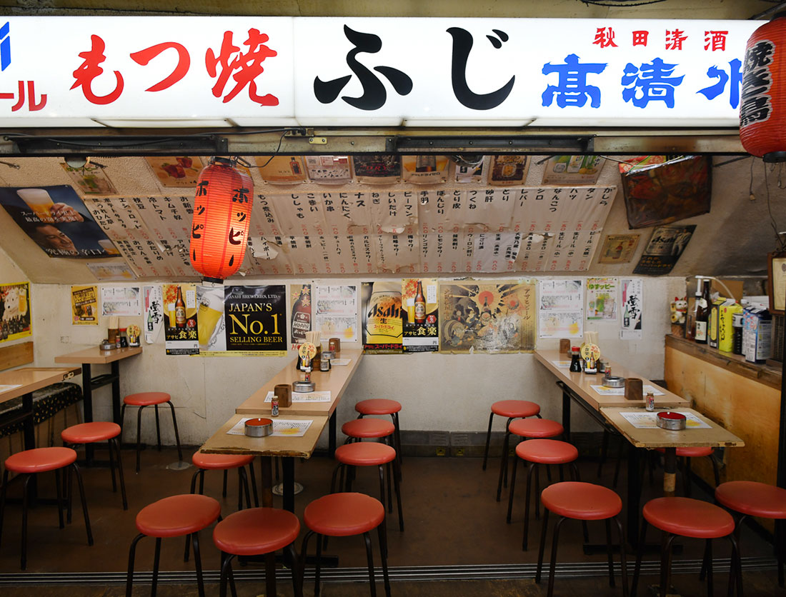 The sign and seating area at Motsuyaki Fuji